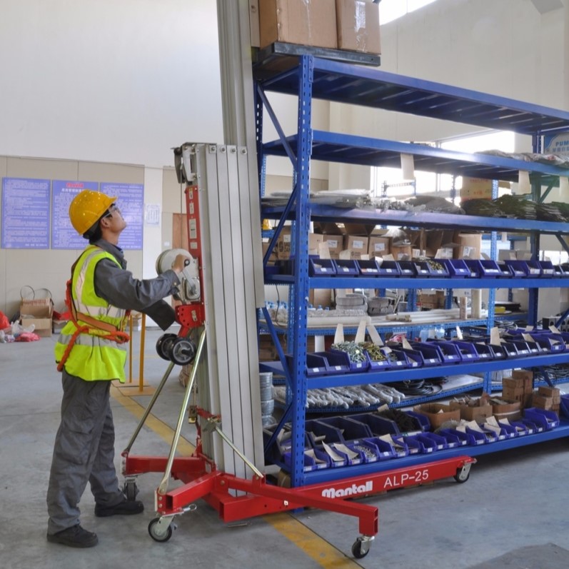 Worker using a Mantall material lift to load stock in a warehouse.